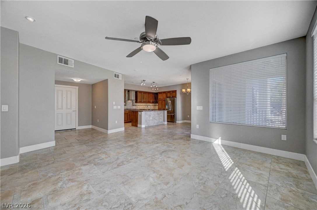 2555 Hampton Road, Unit 6108 Henderson, NV 89052 - Photo 8 of 63 Unfurnished living room featuring a ceiling fan and a chandelier