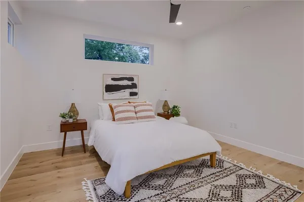 a view of a hallway with a closet and wooden floor