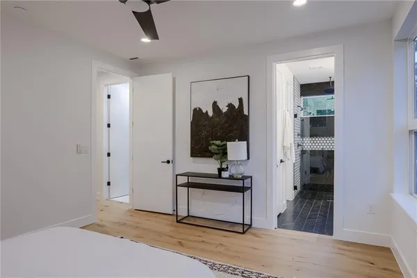a bedroom with a bed and a large window