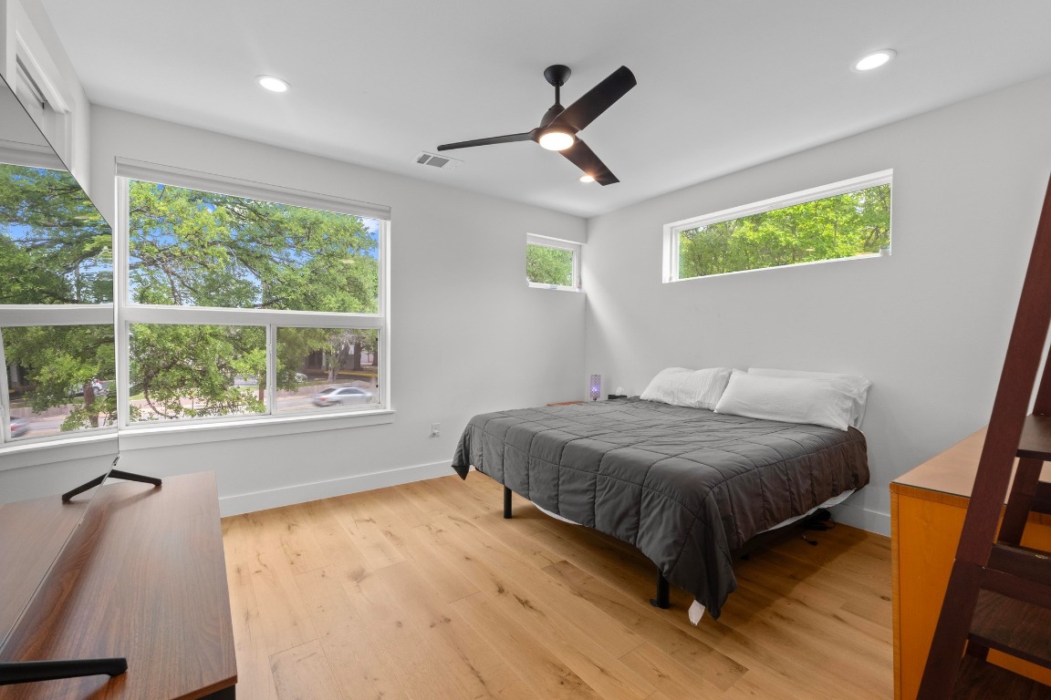 1023 East 45th Street, Unit 1 Austin, TX 78751 - Photo 13 of 30 a bedroom with a bed and a large window