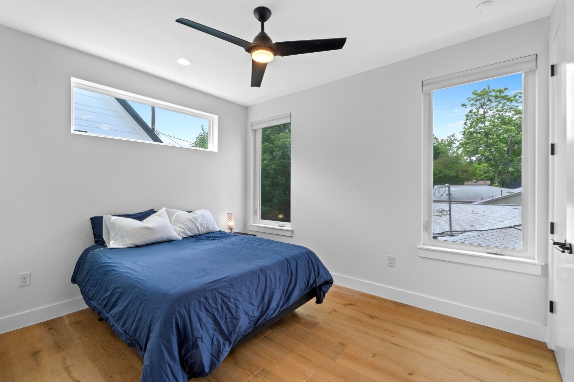 1023 East 45th Street, Unit 1 Austin, TX 78751 - Photo 19 of 30 a bedroom with a bed mirror and window