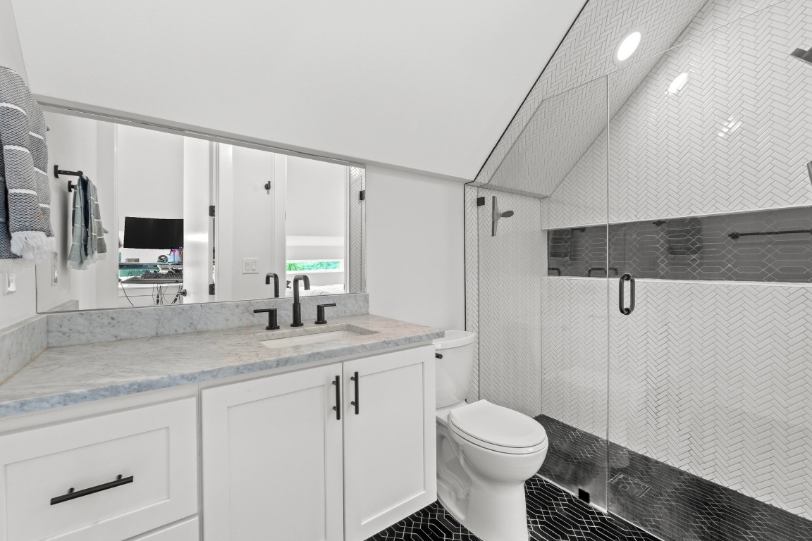 1023 East 45th Street, Unit 1 Austin, TX 78751 - Photo 23 of 30 a bathroom with a granite countertop sink toilet and shower