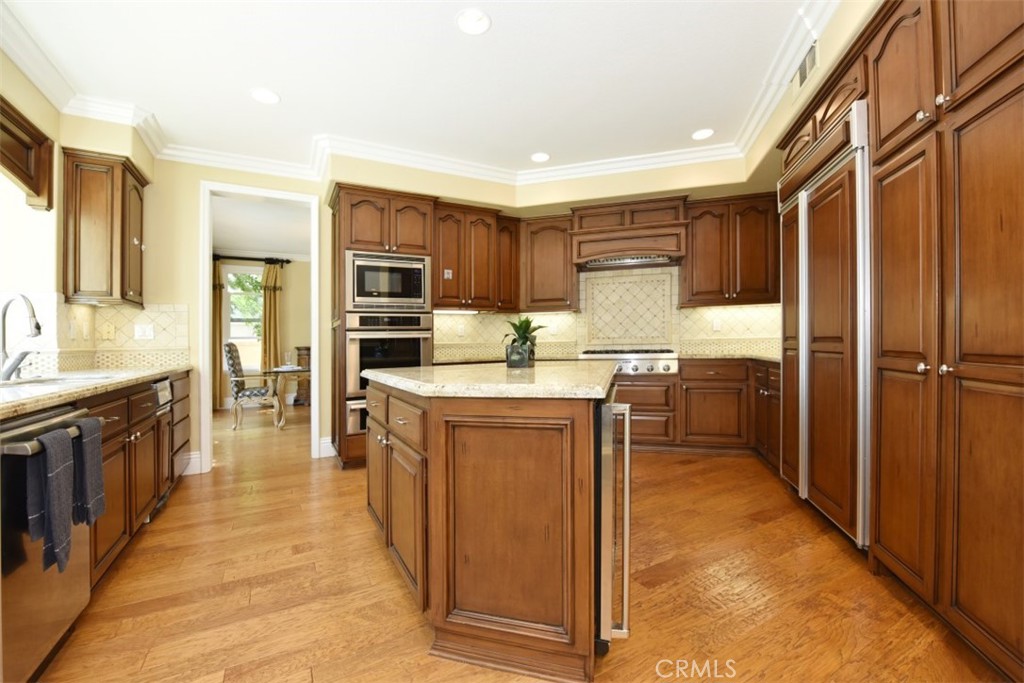 12 Brigadier Irvine, CA 92603 - Photo 11 of 50 a kitchen with kitchen island a counter top space stainless steel appliances and cabinets