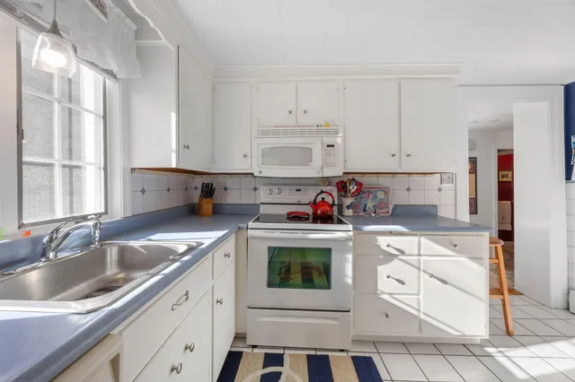 a kitchen with stainless steel appliances a sink and a refrigerator