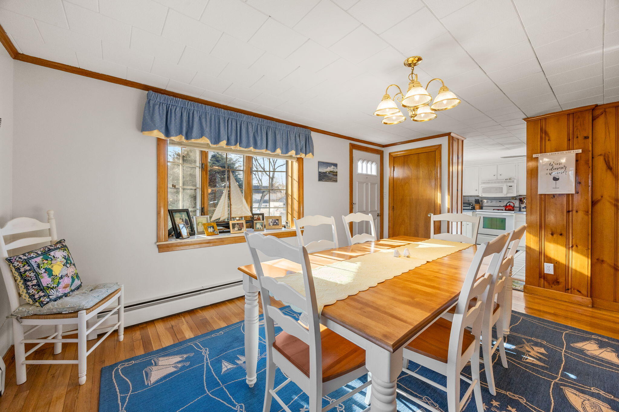 91 Wickertree Road North Falmouth, MA 02556 - Photo 14 of 40 a view of a dining room with furniture a chandelier and wooden floor