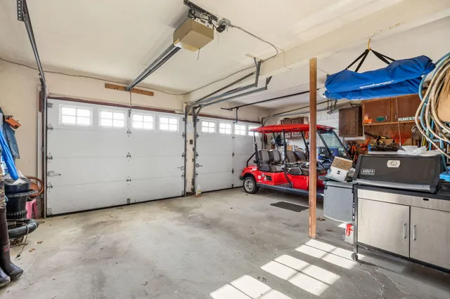a bedroom with a bed and dresser with mirror