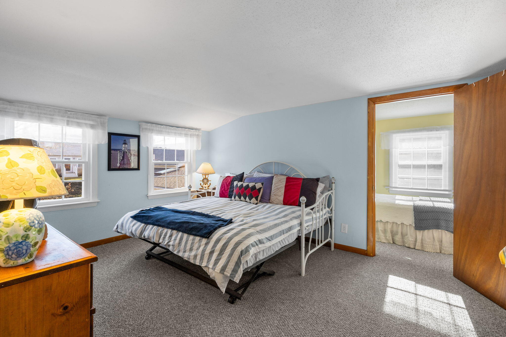 91 Wickertree Road North Falmouth, MA 02556 - Photo 28 of 40 a bedroom with a bed and dresser with mirror