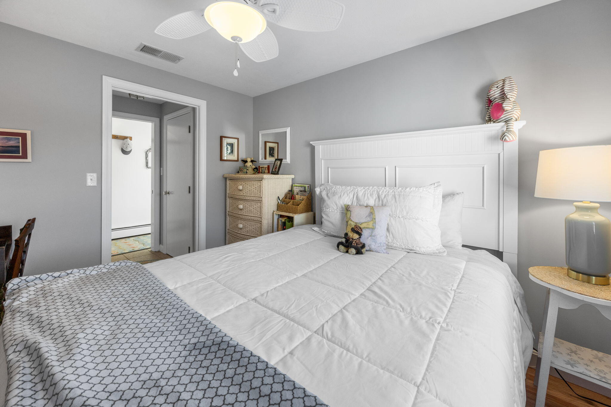 91 Wickertree Road North Falmouth, MA 02556 - Photo 9 of 40 a bedroom with a bed and a chandelier