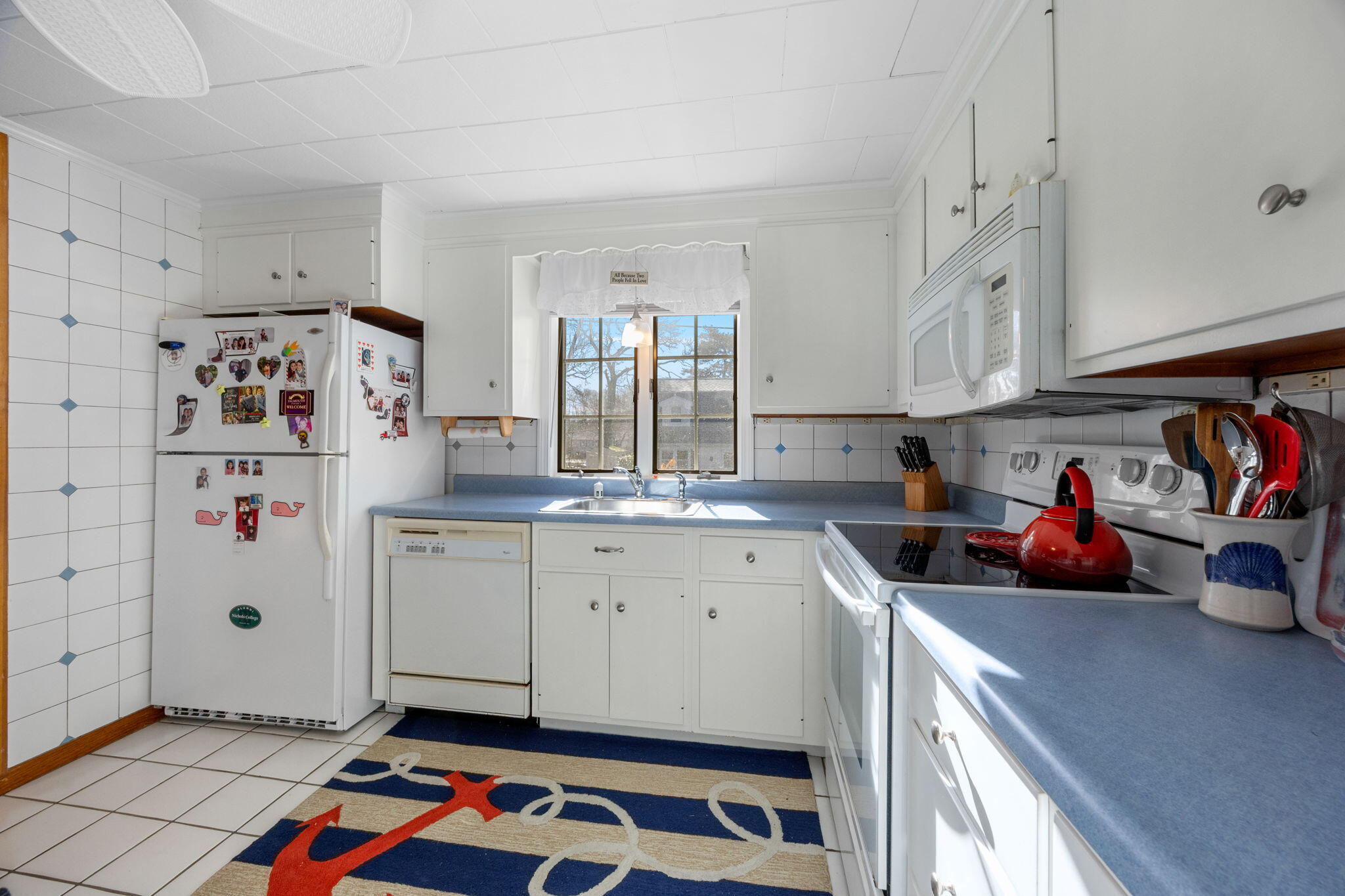 91 Wickertree Road North Falmouth, MA 02556 - Photo 10 of 40 a kitchen with refrigerator and cabinets