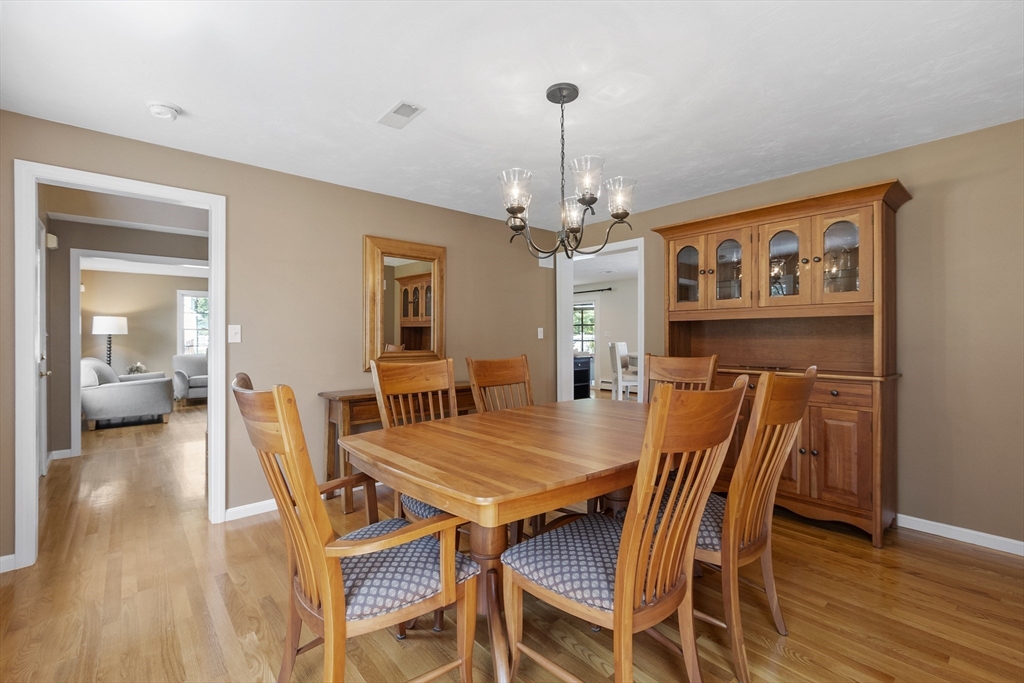 51 Still River Road Bolton, MA 01740 - Photo 13 of 41 a view of a dining room with furniture and wooden floor