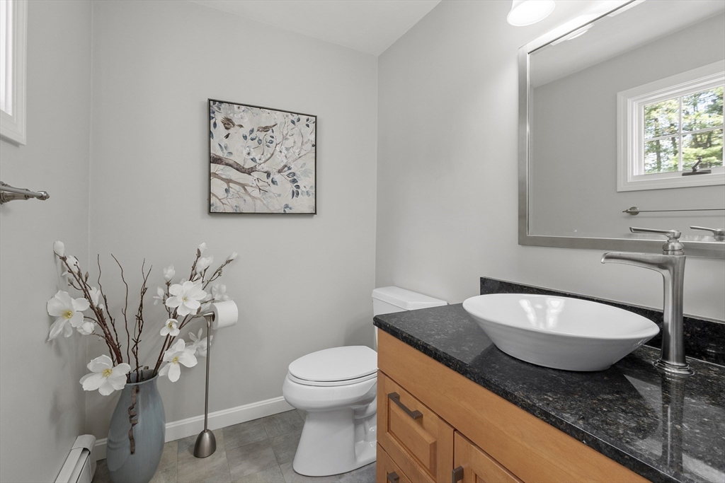 51 Still River Road Bolton, MA 01740 - Photo 17 of 41 a bathroom with a granite countertop toilet and a sink