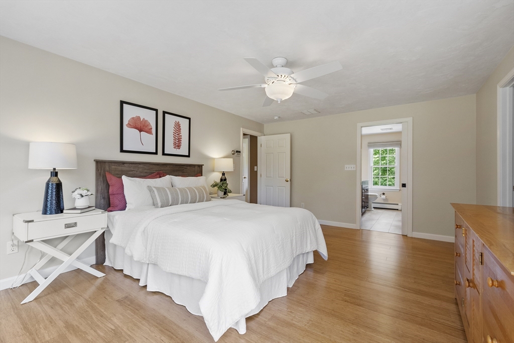 51 Still River Road Bolton, MA 01740 - Photo 19 of 41 a bedroom with a large bed and a chandelier