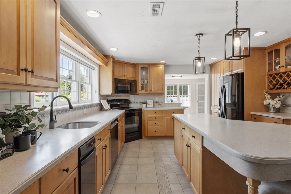 51 Still River Road Bolton, MA 01740 - Photo 5 of 41 a kitchen with a sink stainless steel appliances and cabinets
