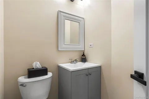 a bathroom with a sink toilet and a mirror