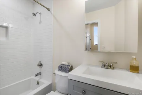 a bathroom with a sink a toilet and bathtub