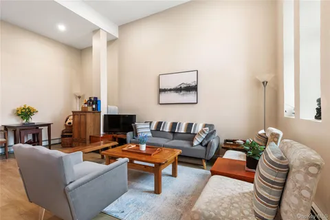 a living room with furniture a rug and a window