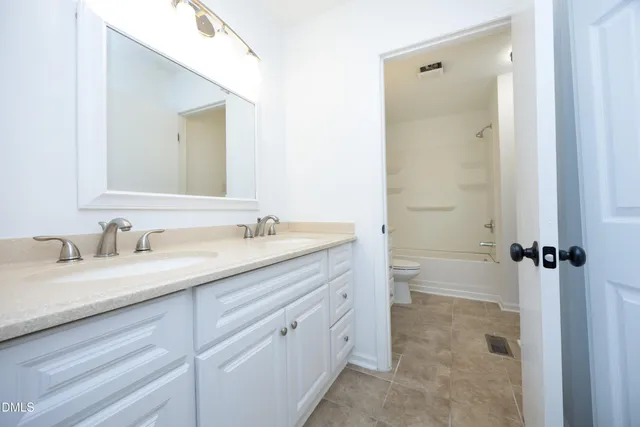 a bathroom with a granite countertop sink mirror and a