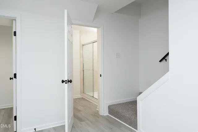 a view of a hallway with wooden floor