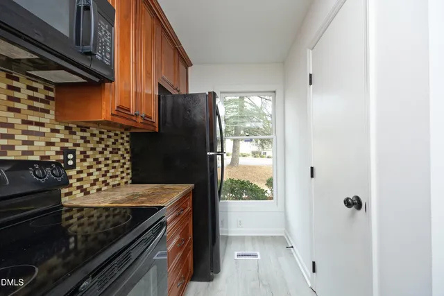 a kitchen with a wooden floor and a stove