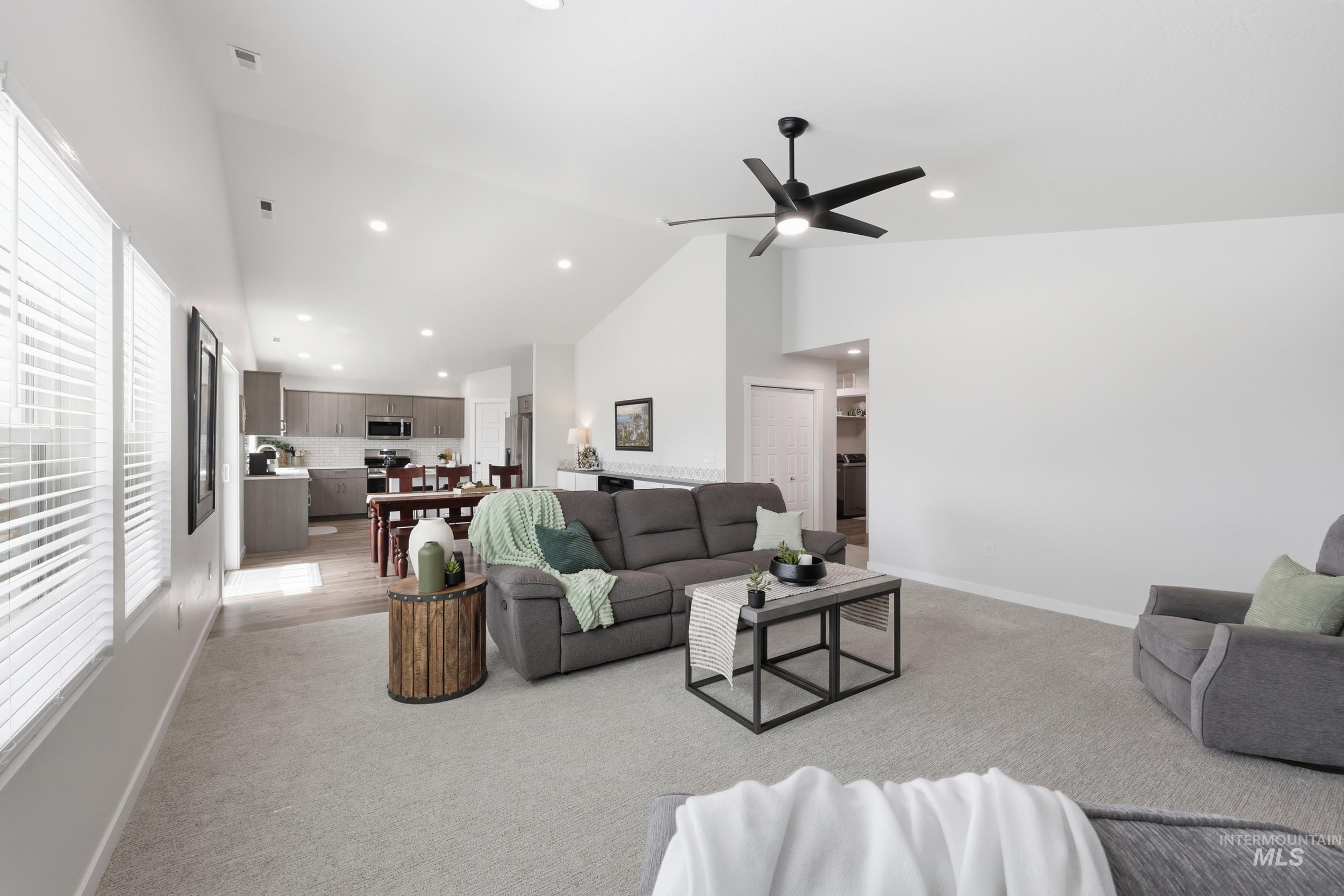3665 W Lane Meridian, ID 83642 - Photo 16 of 42 Open-concept living space featuring vaulted ceilings, recessed lighting, and light-toned carpeting