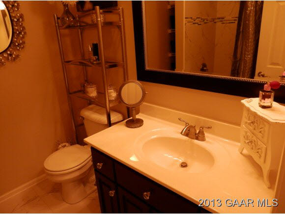2198 Lyndhurst Road Waynesboro, VA 22980 - Photo 19 of 27 a bathroom with a sink mirror vanity and toilet