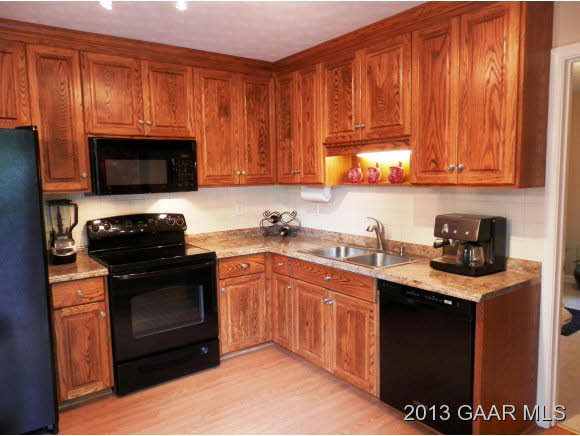 2198 Lyndhurst Road Waynesboro, VA 22980 - Photo 6 of 27 a kitchen with granite countertop a stove top oven cabinetry a sink and dishwasher