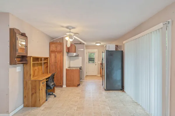 a view of a kitchen with refrigerator and cabinet