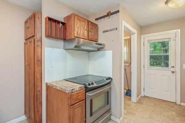 a kitchen with a stove and a refrigerator