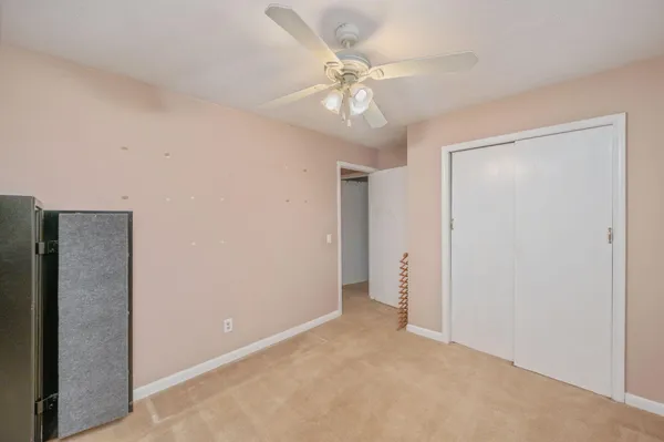 a view of an empty room with a ceiling fan