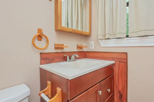 a kitchen with a sink cabinets and a wooden floor