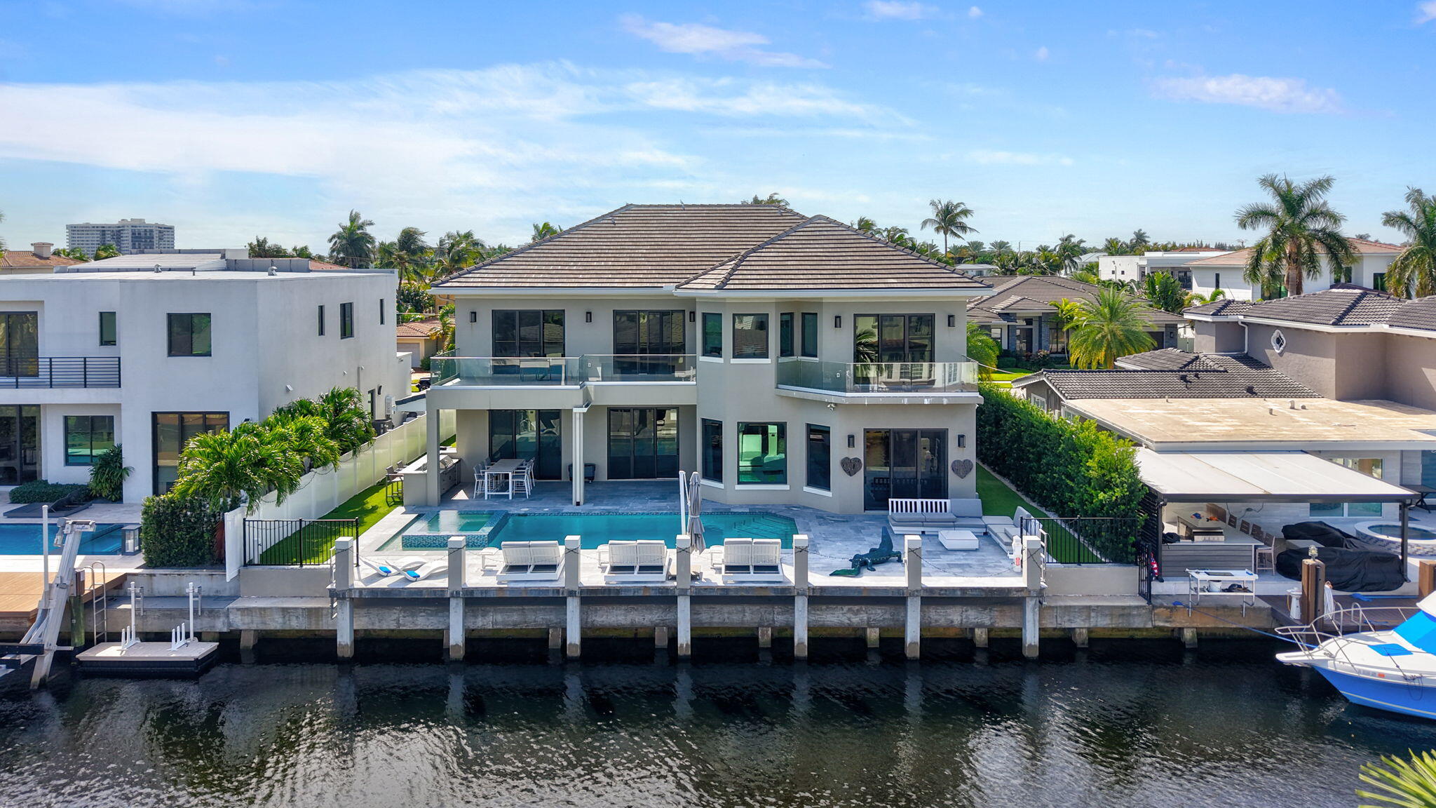 a view of house with swimming pool and outdoor seating