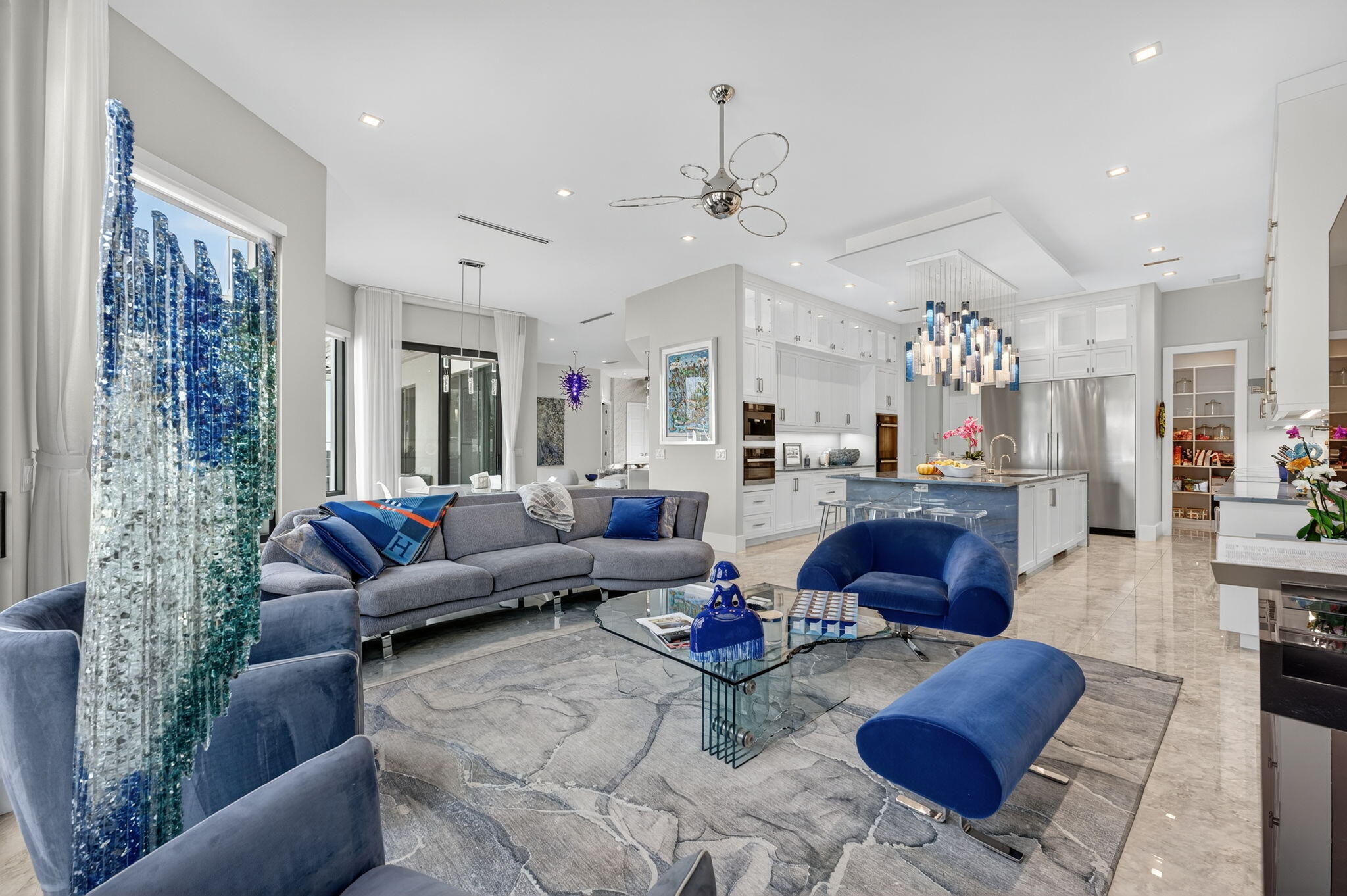 785 Northeast 70th Street Boca Raton, FL 33487 - Photo 20 of 80 a living room with lots of furniture and a chandelier