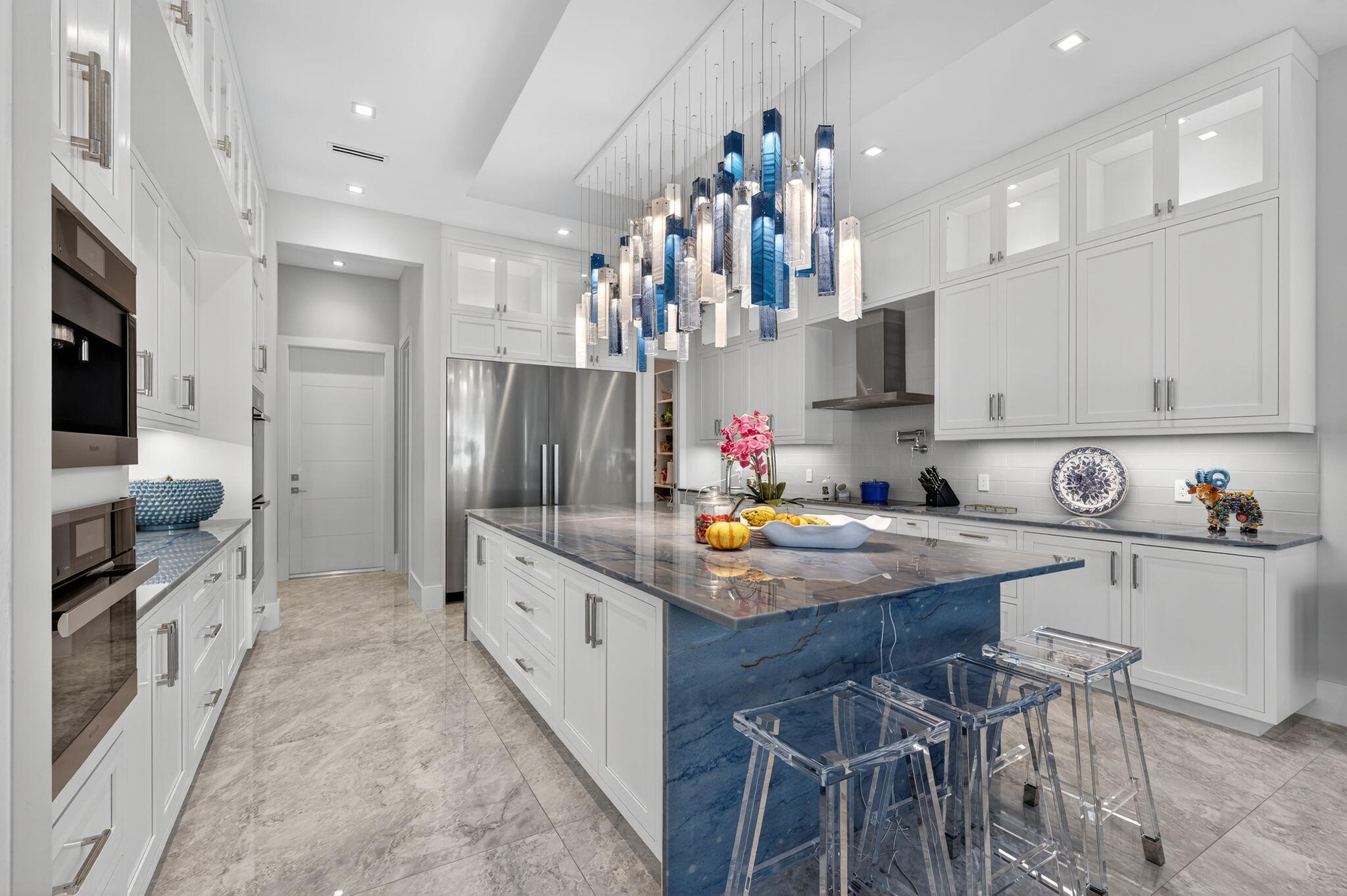 785 Northeast 70th Street Boca Raton, FL 33487 - Photo 23 of 80 a kitchen with kitchen island granite countertop lots of counter top space and stainless steel appliances