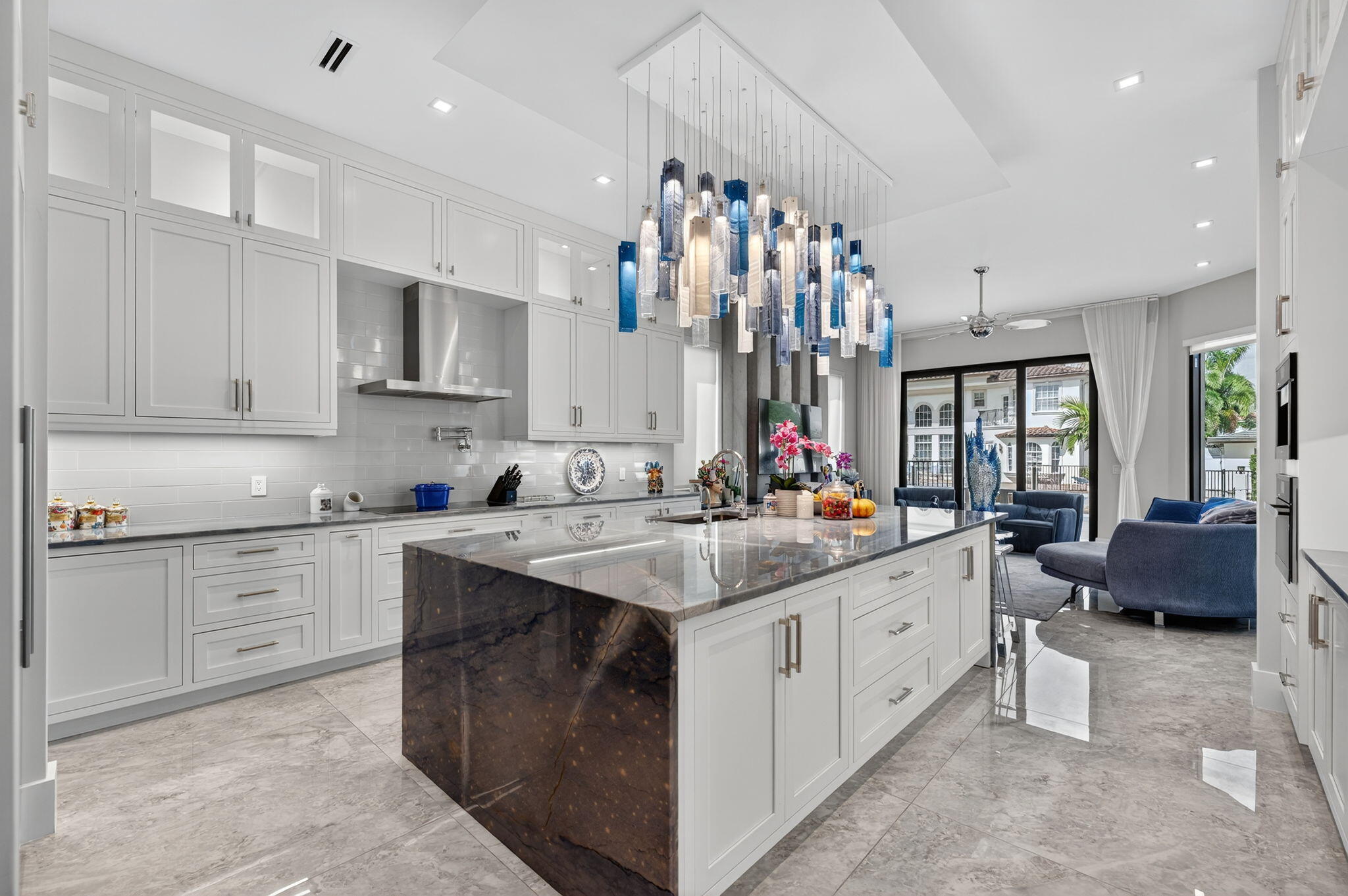 785 Northeast 70th Street Boca Raton, FL 33487 - Photo 24 of 80 a kitchen that has a lot of cabinets in it and wooden floors