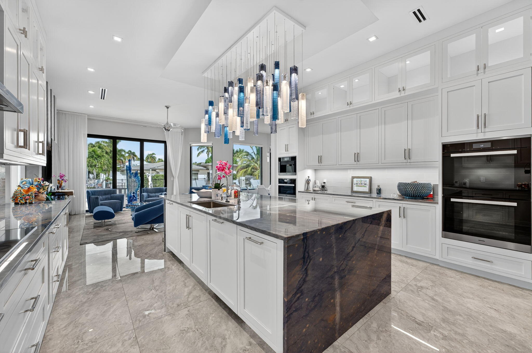 785 Northeast 70th Street Boca Raton, FL 33487 - Photo 26 of 80 a kitchen with kitchen island granite countertop a sink counter top space appliances and cabinets