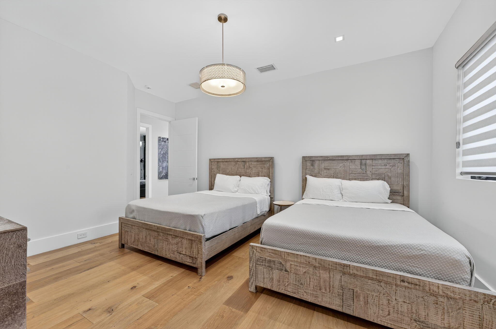 785 Northeast 70th Street Boca Raton, FL 33487 - Photo 47 of 80 a spacious bedroom with two bed and a window