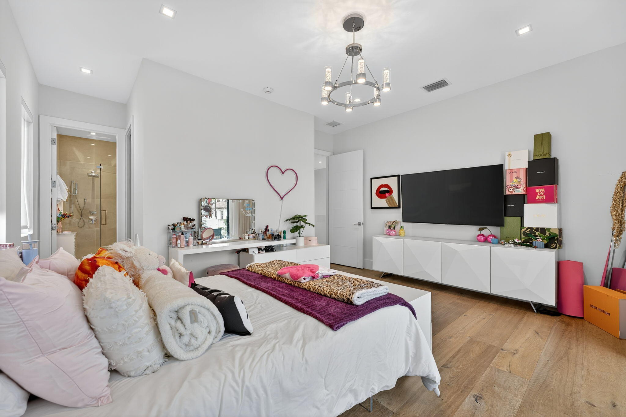 785 Northeast 70th Street Boca Raton, FL 33487 - Photo 56 of 80 a bedroom with bed and a flat tv screen on dresser