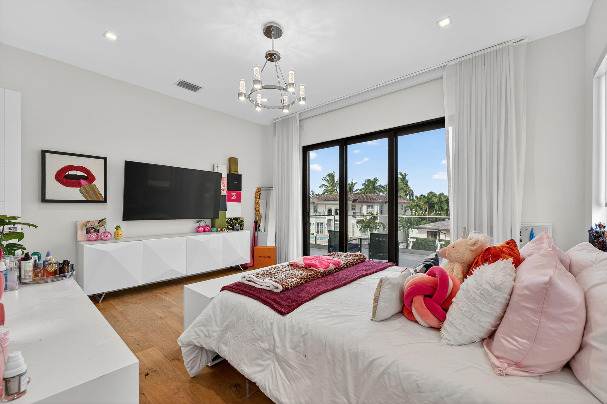 785 Northeast 70th Street Boca Raton, FL 33487 - Photo 58 of 80 a bedroom with a bed and a flat screen tv