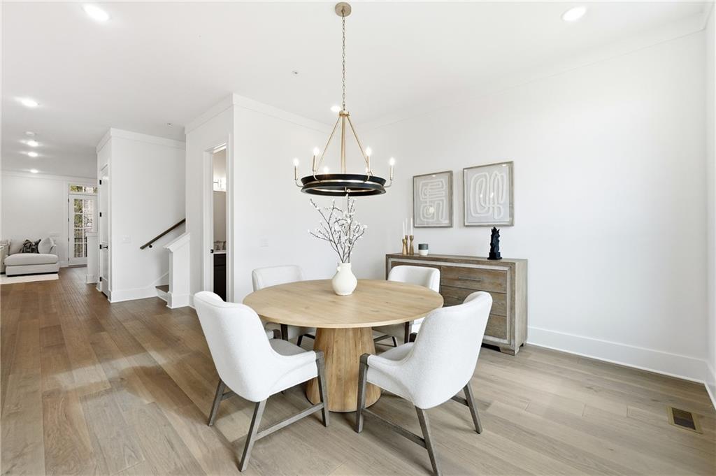 531 South Main Street, Unit 320 Alpharetta, GA 30009 - Photo 11 of 43 a view of a dining room with furniture and wooden floor