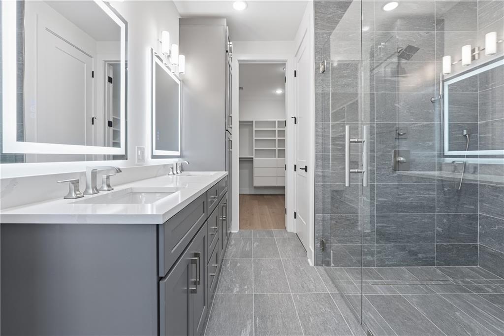 531 South Main Street, Unit 320 Alpharetta, GA 30009 - Photo 15 of 43 a bathroom with a sink double vanity and shower