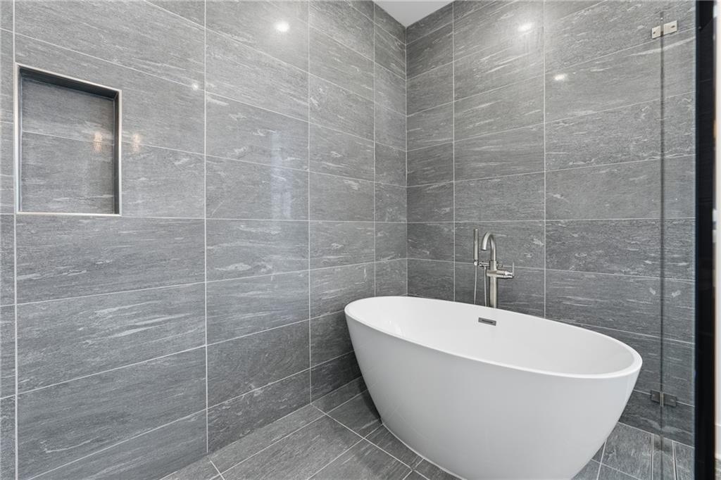 531 South Main Street, Unit 320 Alpharetta, GA 30009 - Photo 16 of 43 a white bath tub sitting in a bathroom