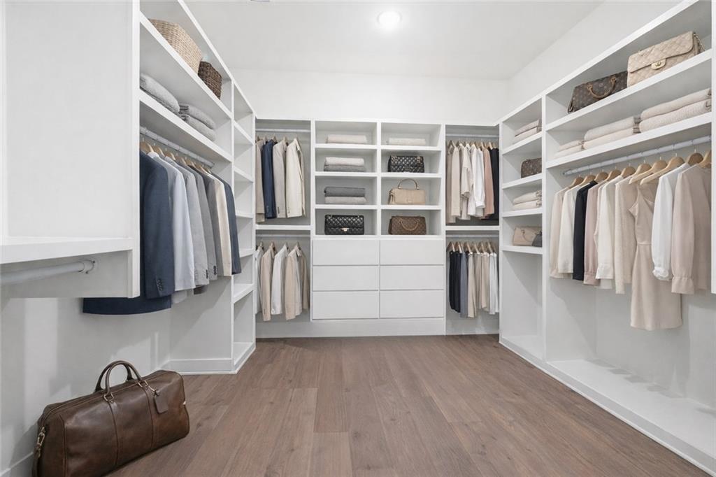 531 South Main Street, Unit 320 Alpharetta, GA 30009 - Photo 17 of 43 a view of walk in closet with clothes and shoes