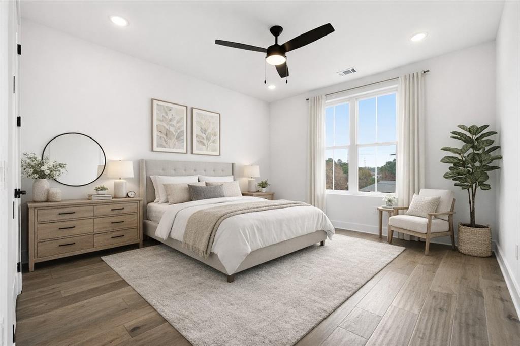 531 South Main Street, Unit 320 Alpharetta, GA 30009 - Photo 24 of 43 a spacious bedroom with a large bed and a chandelier