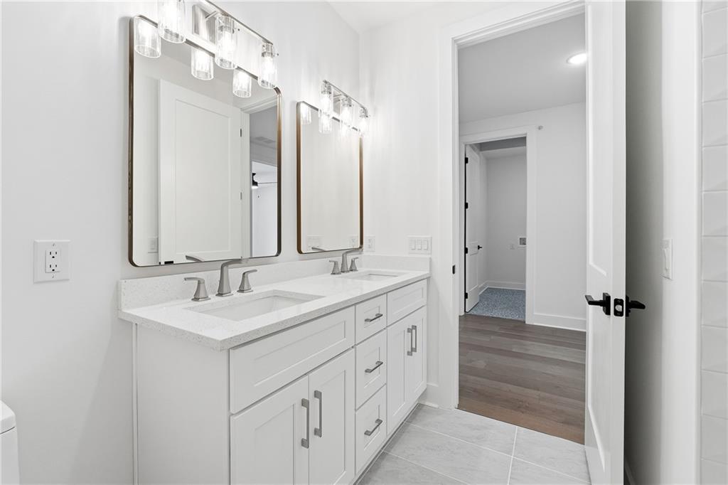 531 South Main Street, Unit 320 Alpharetta, GA 30009 - Photo 25 of 43 a bathroom with double vanity sinks and a mirror