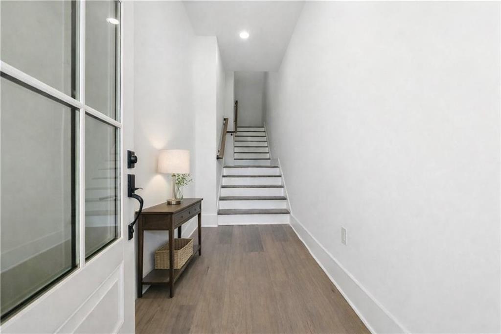 531 South Main Street, Unit 320 Alpharetta, GA 30009 - Photo 35 of 43 a view of a hallway with wooden floor and stairs
