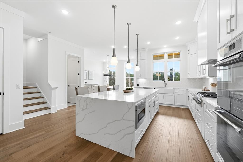 531 South Main Street, Unit 320 Alpharetta, GA 30009 - Photo 6 of 43 a large white kitchen with stainless steel appliances