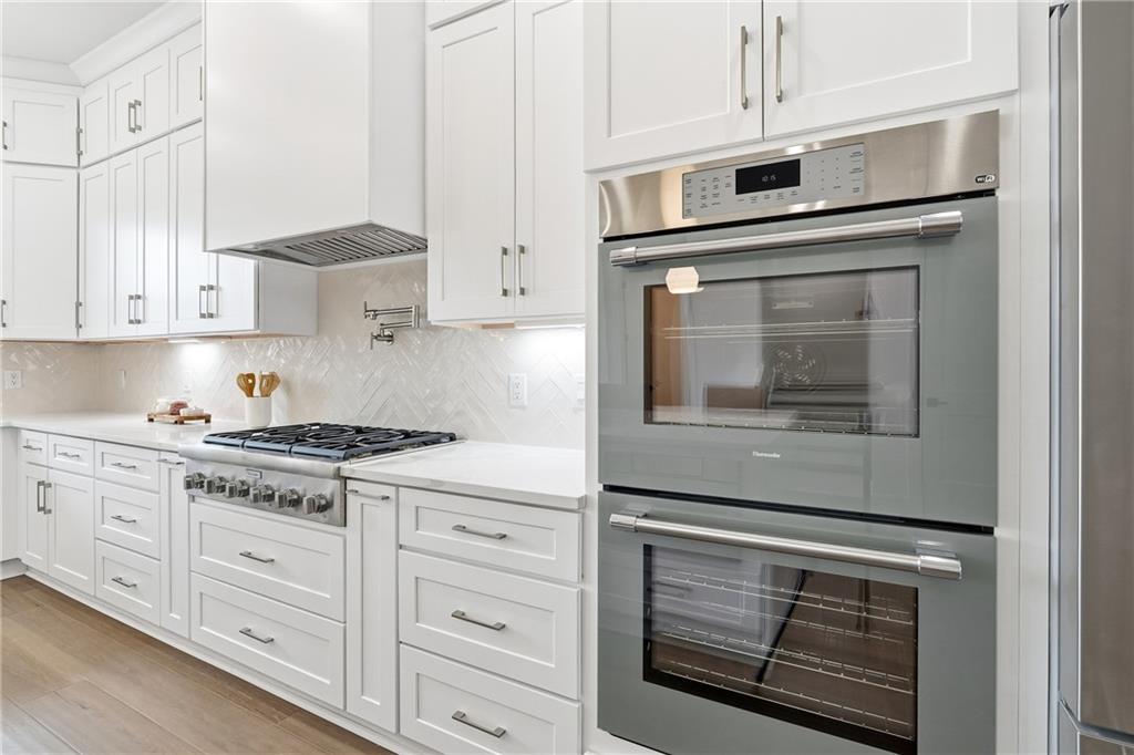 531 South Main Street, Unit 320 Alpharetta, GA 30009 - Photo 7 of 43 a kitchen with granite countertop cabinets stainless steel appliances and a counter space