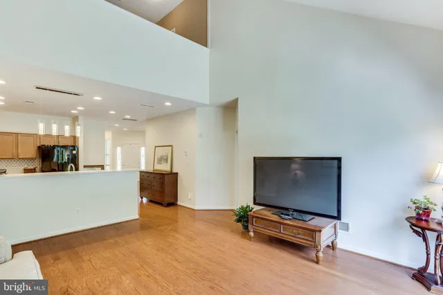 a living room with furniture pool table and a flat screen tv