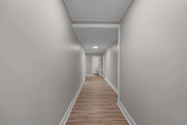 a view of a hallway with wooden floor
