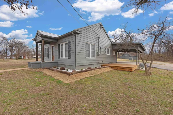 a house view with swimming pool and porch
